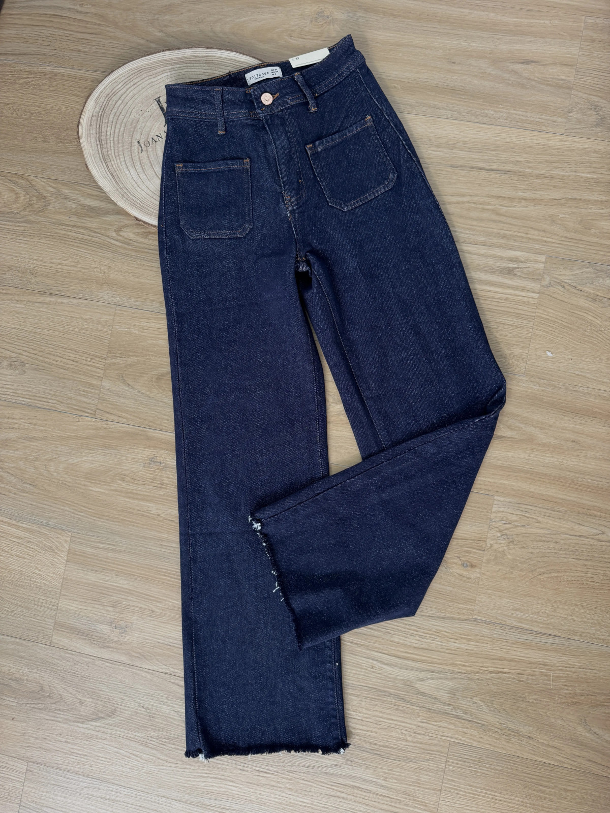 Pantalón vaquero oscuro con bolsillos en parte delantera.